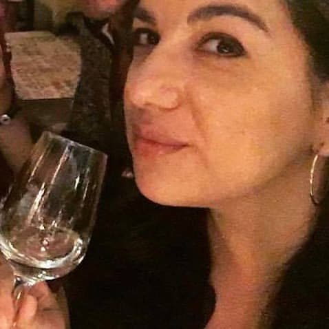 Maria Massoura with a glass of white wine